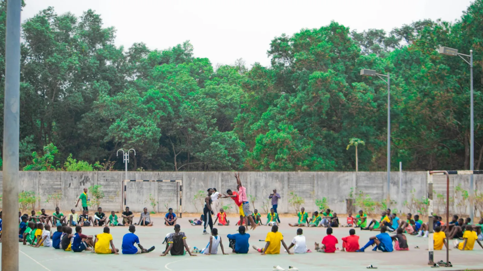 A group of people gathered together outdoors for a coached group training session, the kind of cohort this cost ledger prices at 25, 50 and 100 clients