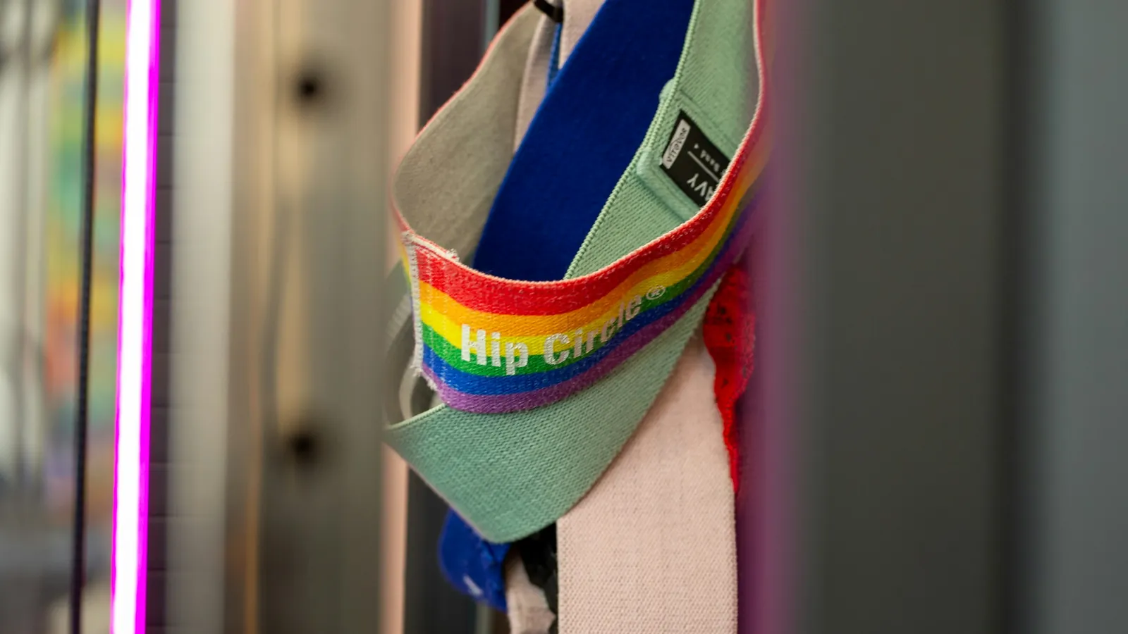 Fabric hip circle bands hanging in a gym, the kind of low-cost kit behind the prehab drills coaches program