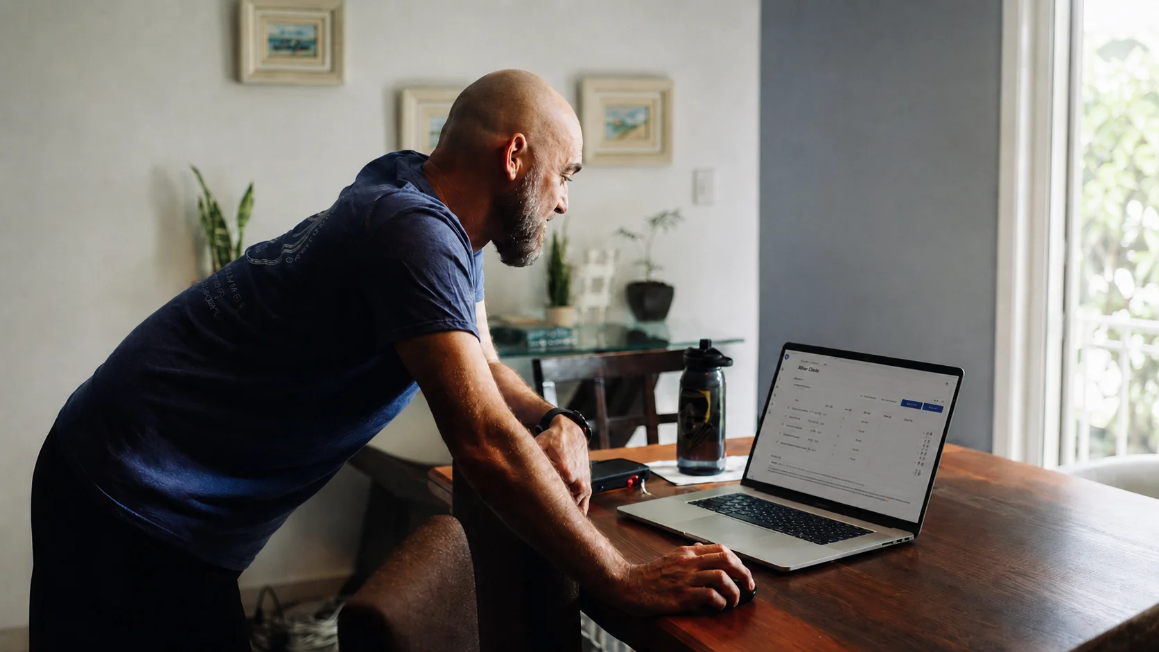 Coach reviewing QuickCoach Pro client dashboard on a laptop