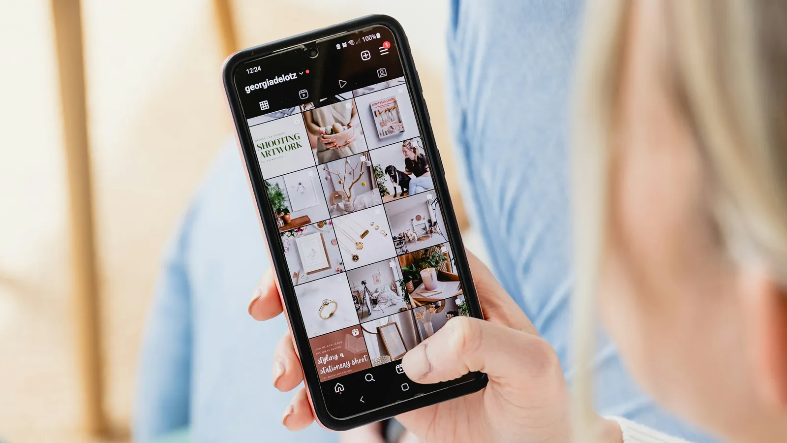 A coach's phone showing a branded client app beside a social profile, the one-brand rule connecting the follower to the product